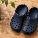 are Crocs bad for your feet, a pair of classic Crocs clogs on a wooden floor