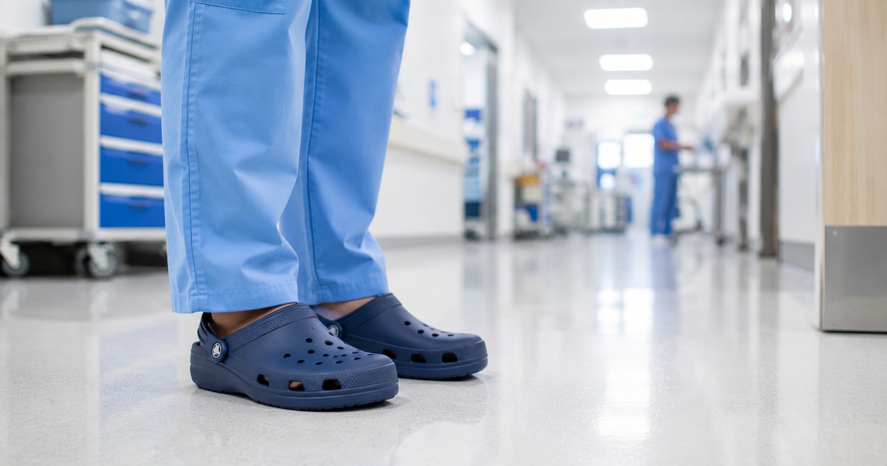 Crocs for healthcare workers, a nurse in scrubs wearing Crocs clogs on a hospital floor