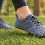 how to transition to barefoot shoes safely, a person walking gently in minimalist shoes on grass